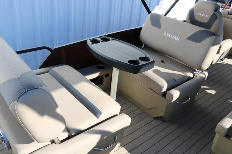 Slide: The Image of 2024 Sylvan L3 RLZ boat interior with beige seating and a central table. - 24
