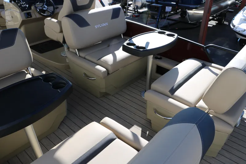 Slide: The Image of 2024 Sylvan L3 RLZ boat interior with beige seating and cup holders. - 25