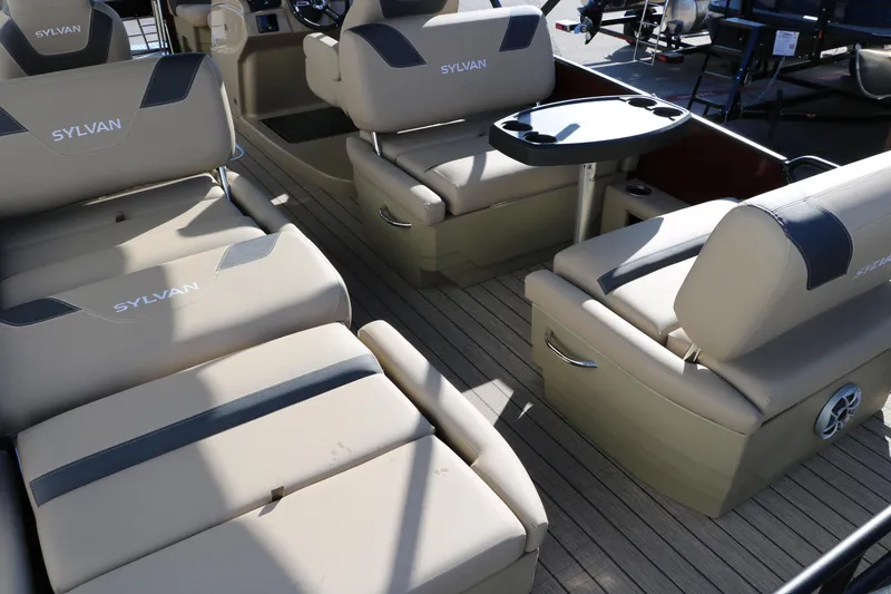 Slide: The Image of 2024 Sylvan L3 RLZ boat interior with beige seating and table. - 26