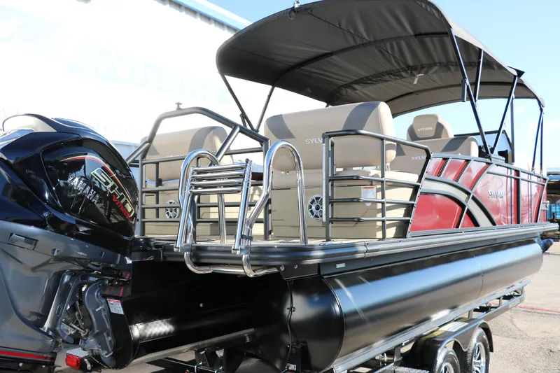 Slide: The Image of 2024 Sylvan L3 RLZ pontoon boat with black and red exterior and beige seating. - 3