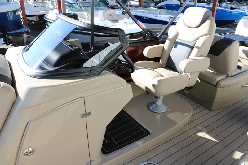 Slide: The Image of 2024 Sylvan L3 RLZ boat interior with captain's chair and dashboard. - 31
