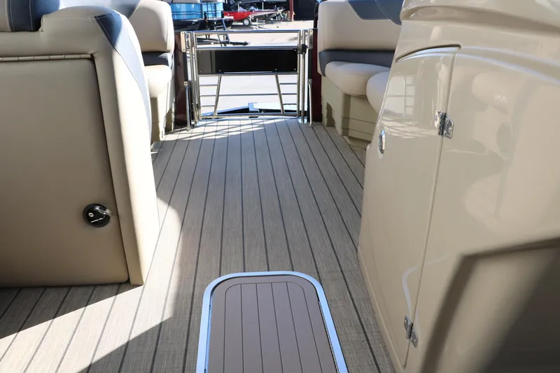 Slide: The Image of 2024 Sylvan L3 RLZ boat interior with beige seating and wood-like flooring. - 37