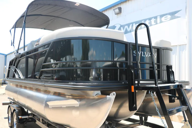 Slide: The Image of 2025 Sylvan X1 CLZ DH Tri-Toon boat with black exterior on trailer. - 11