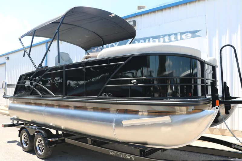 Slide: The Image of 2025 Sylvan X1 CLZ DH Tri-Toon boat on trailer outside dealership. - 12
