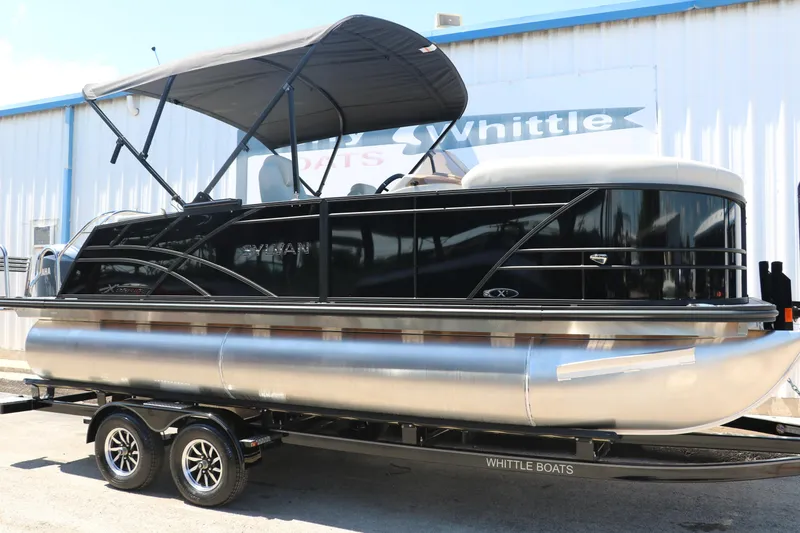Slide: The Image of 2025 Sylvan X1 CLZ DH Tri-Toon boat on trailer outside dealership. - 13