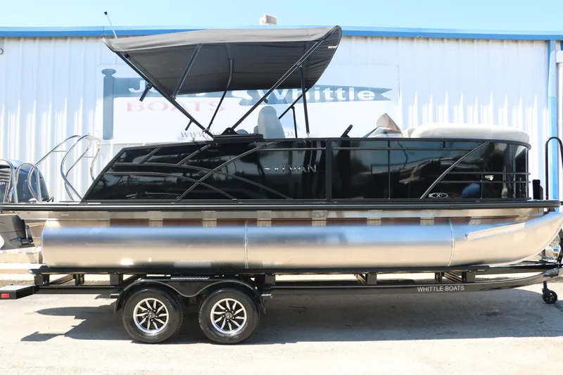 Slide: The Image of 2025 Sylvan X1 CLZ DH Tri-Toon boat on a trailer outside a dealership. - 14