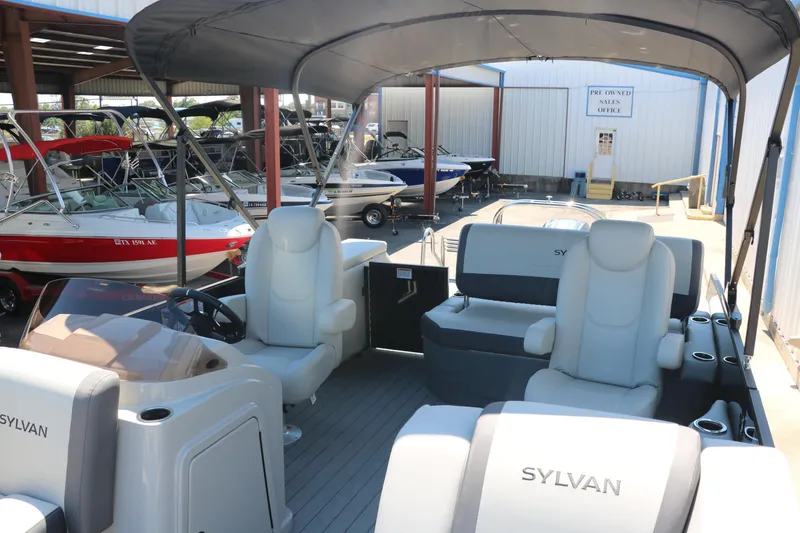 Slide: The Image of 2025 Sylvan X1 CLZ DH Tri-Toon boat interior with seating and canopy. - 19