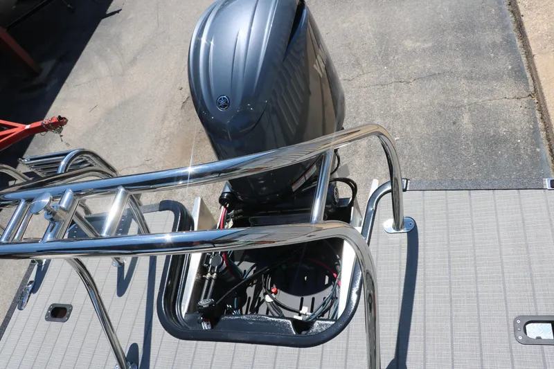 Slide: The Image of 2025 Sylvan X1 CLZ DH Tri-Toon boat with outboard motor and stainless steel railing. - 23