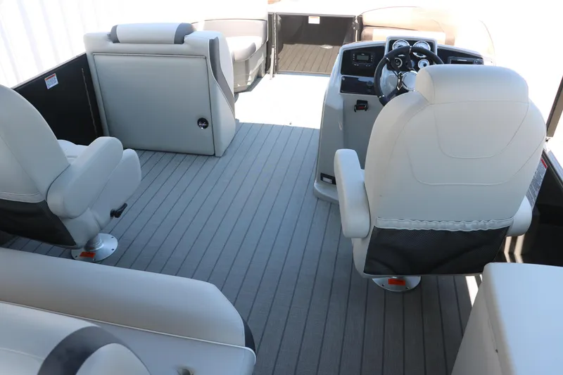 Slide: The Image of 2025 Sylvan X1 CLZ DH Tri-Toon boat interior with modern seating and steering console. - 24