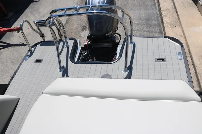 Slide: The Image of 2025 Sylvan X1 CLZ DH Tri-Toon boat with outboard motor and rear deck. - 28