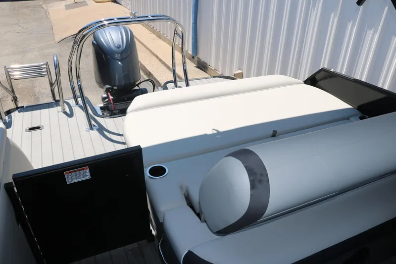 Slide: The Image of 2025 Sylvan X1 CLZ DH Tri-Toon boat with rear seating and outboard motor. - 33