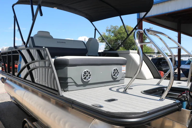 Slide: The Image of 2025 Sylvan X1 CLZ DH Tri-Toon boat with rear seating and speakers. - 7