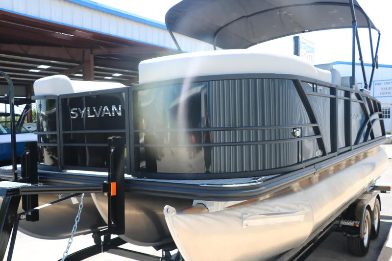 Slide: The Image of 2025 Sylvan X1 CLZ DH Tri-Toon pontoon boat on a trailer. - 8