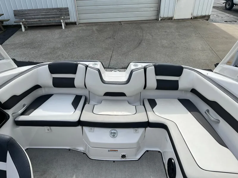 Slide: The Image of 2021 Yamaha Boats AR 195 interior seating area with white and black upholstery. - 4