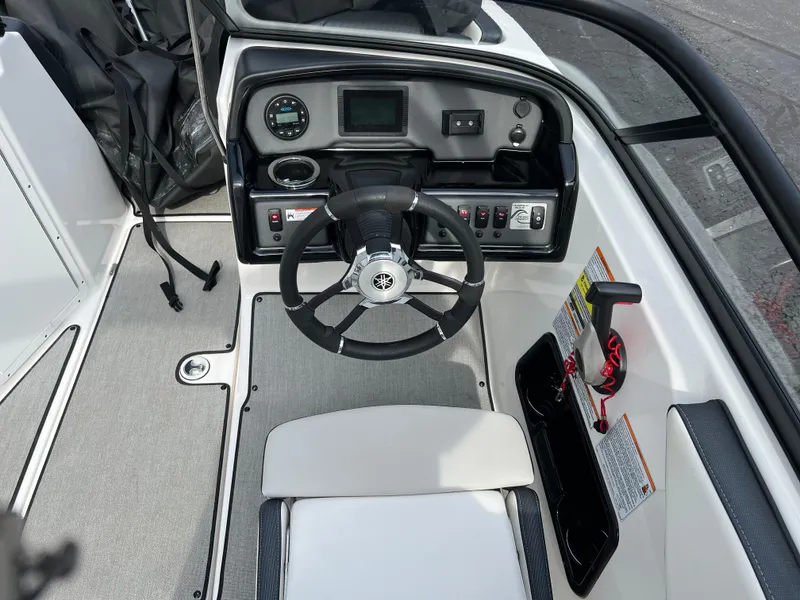 Slide: The Image of 2021 Yamaha Boats AR 195 cockpit with steering wheel and control panel. - 5