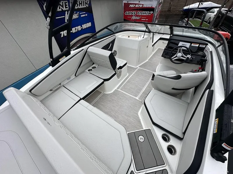 Slide: The Image of 2024 Sea Ray SPX 210 boat interior with white seating and modern dashboard. - 10