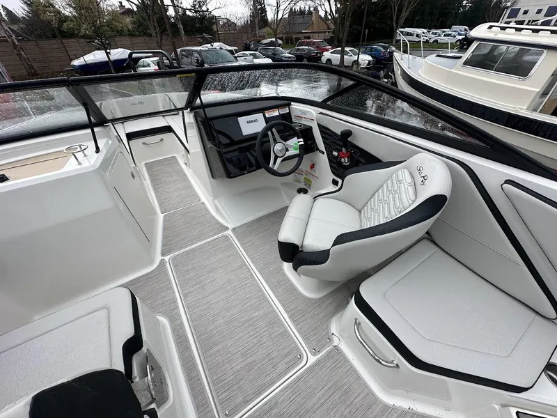 Slide: The Image of 2024 Sea Ray SPX 210 boat interior with modern helm and seating. - 11