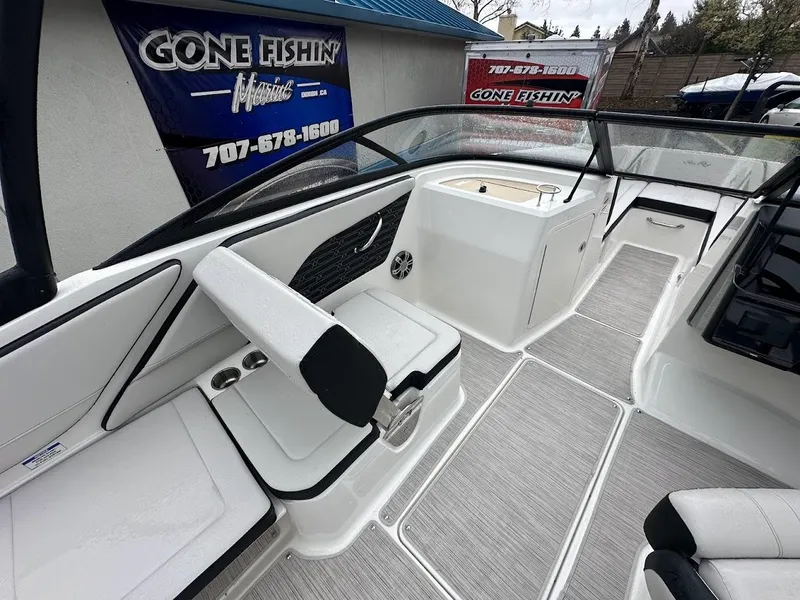 Slide: The Image of 2024 Sea Ray SPX 210 boat interior with seating and console. - 12