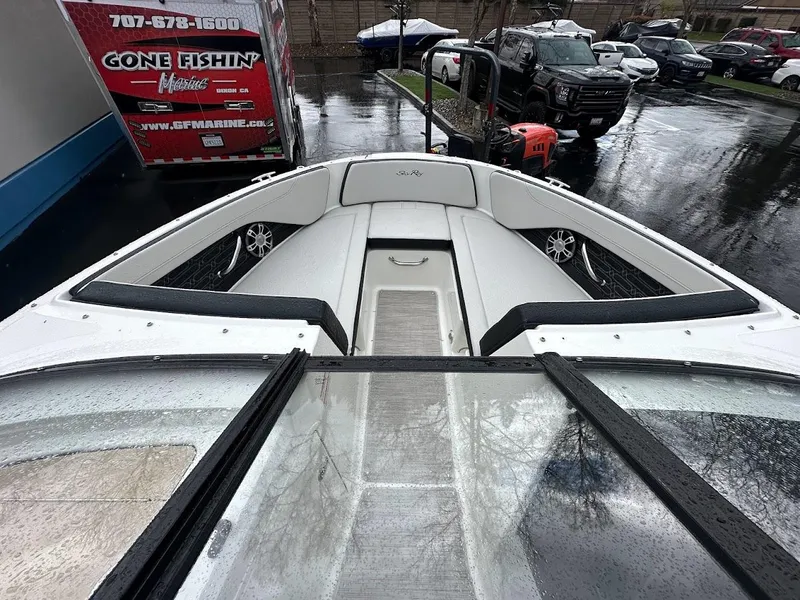Slide: The Image of 2024 Sea Ray SPX 210 boat interior, bow seating area, wet conditions. - 14