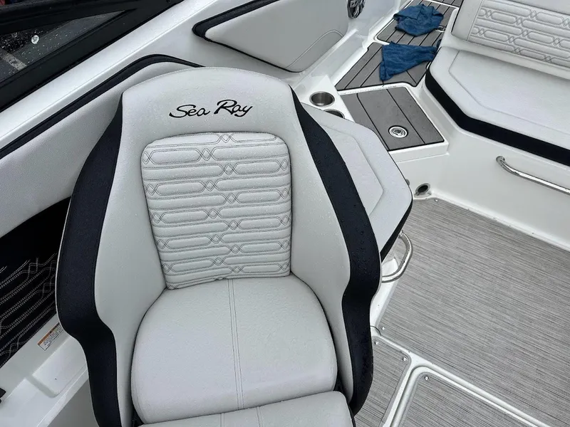 Slide: The Image of 2024 Sea Ray SPX 210 boat interior with white and black seating. - 19