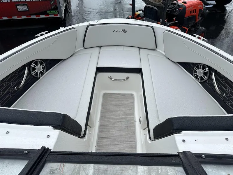 Slide: The Image of 2024 Sea Ray SPX 210 boat interior with white and black seating. - 25