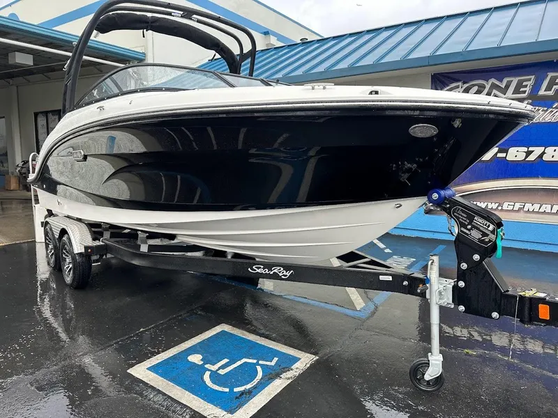 Slide: The Image of 2024 Sea Ray SPX 210 boat on trailer in parking lot. - 27