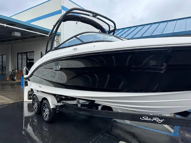 Slide: The Image of 2024 Sea Ray SPX 210 boat on a trailer outside a dealership. - 28
