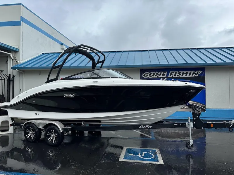 Slide: The Image of 2024 Sea Ray SPX 210 boat on trailer outside dealership. - 29
