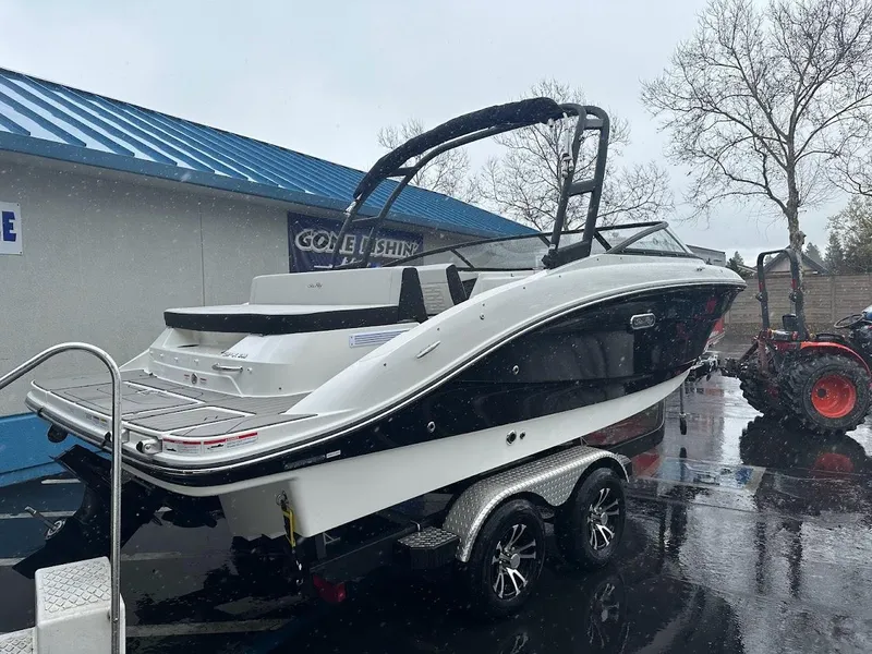 Slide: The Image of 2024 Sea Ray SPX 210 boat on a trailer in a dealership lot. - 5