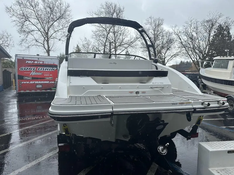 Slide: The Image of 2024 Sea Ray SPX 210 boat rear view in a rainy marina. - 6