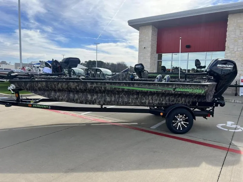 Slide: The Image of 2024 Havoc Boats 1756 FRRSCST fishing boat on trailer with Mercury outboard motor. - 2