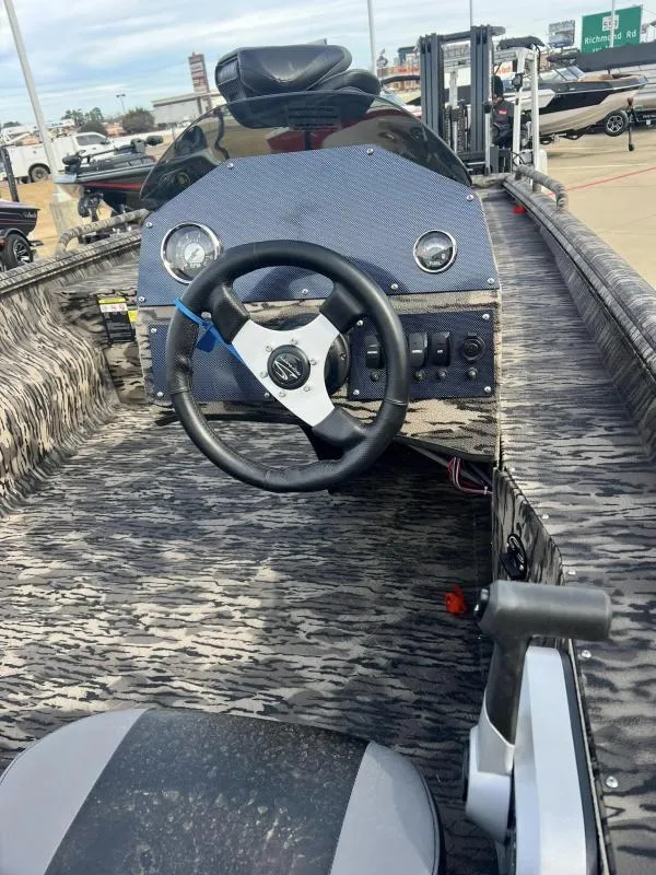 Slide: The Image of 2024 Havoc Boats 1756 FRRSCST interior with steering wheel and dashboard. - 9