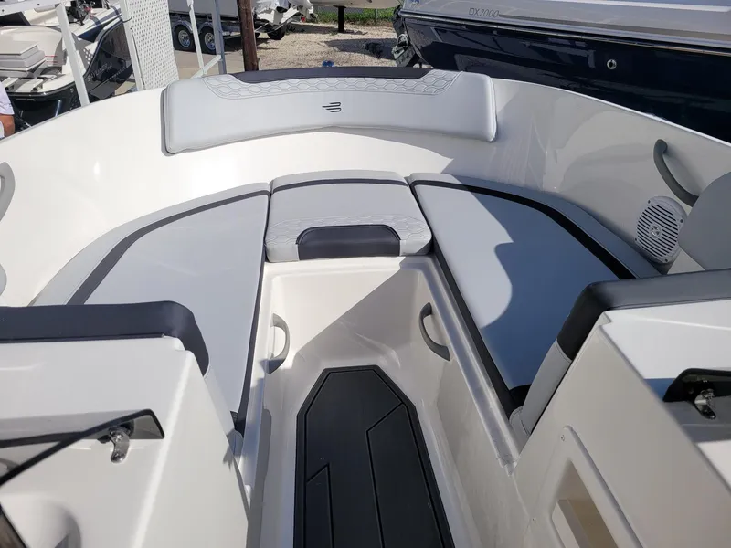 Slide: The Image of 2024 Bayliner M17 boat interior with cushioned seating and storage compartments. - 10