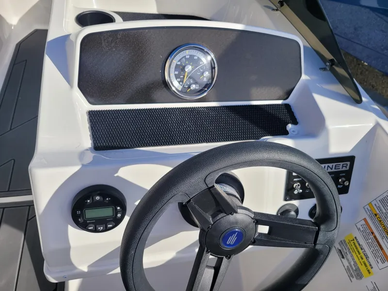 Slide: The Image of 2024 Bayliner M17 boat dashboard with steering wheel and gauges. - 12