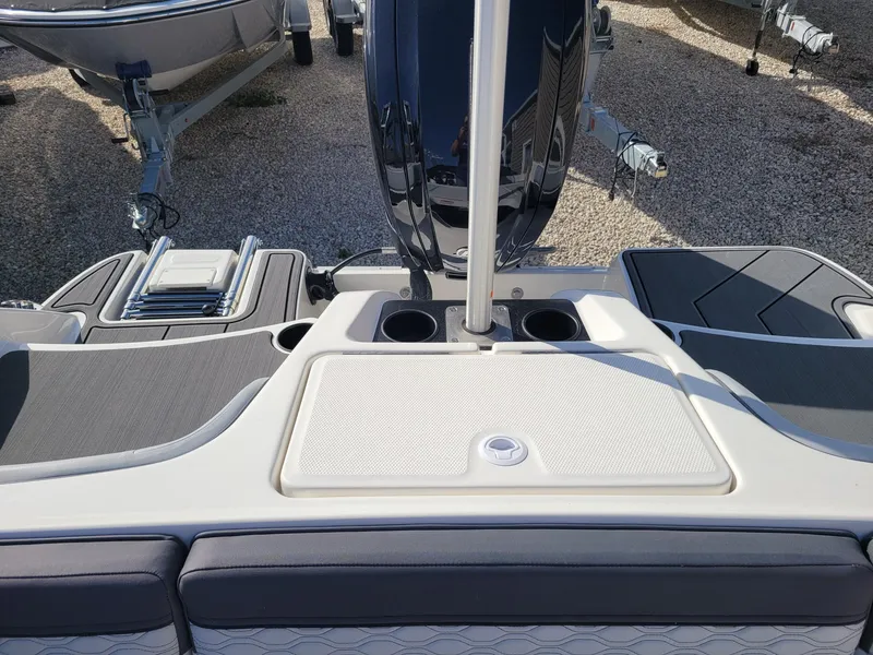 Slide: The Image of 2024 Bayliner M17 boat stern with motor and seating area. - 5