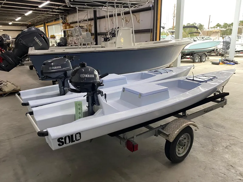 Slide: The Image of 2025 Solo Skiff 145 boats with Yamaha motors on a trailer in a warehouse. - 3