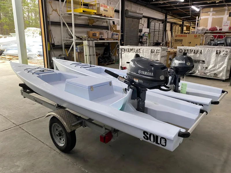 Slide: The Image of 2025 Solo Skiff 145 boats with Yamaha motors on a trailer in a warehouse. - 5
