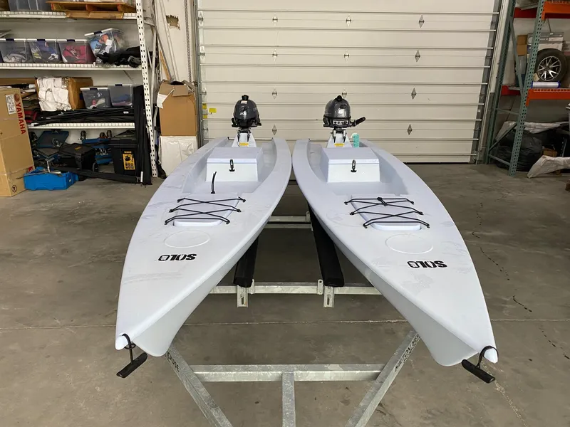 Slide: The Image of Two 2025 Solo Skiff 145 boats with motors in a garage setting. - 6