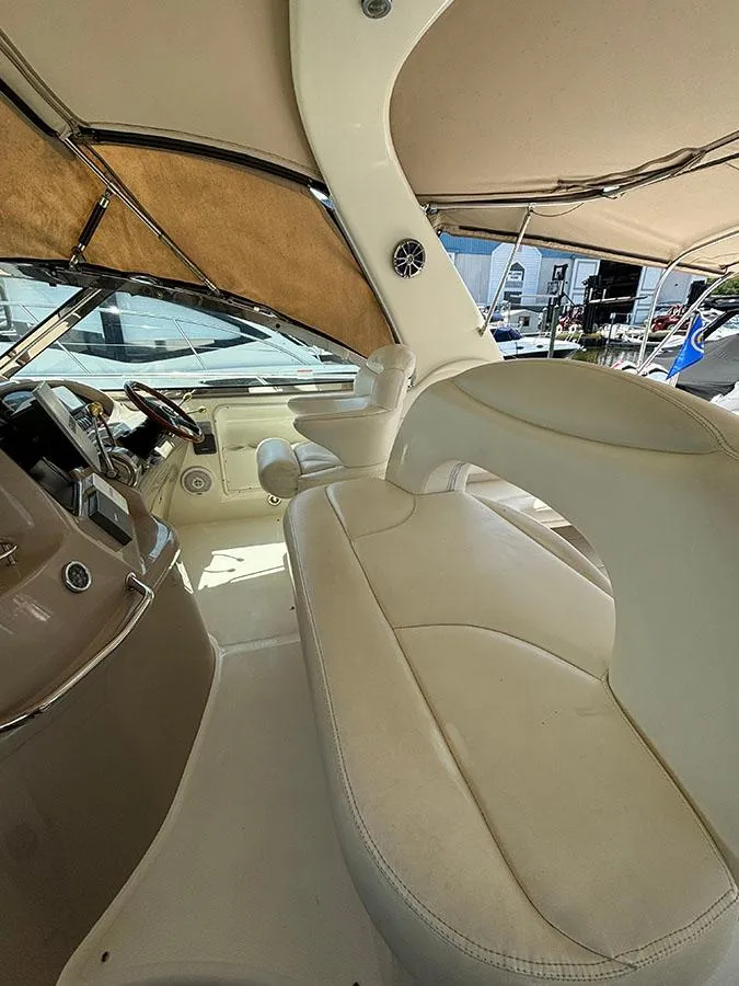 Slide: The Image of Interior view of a 2001 Sea Ray 410 Sundancer yacht with beige seating. - 10