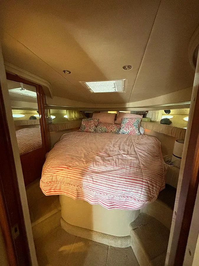 Slide: The Image of Interior cabin of 2001 Sea Ray 410 Sundancer yacht with cozy bed. - 16