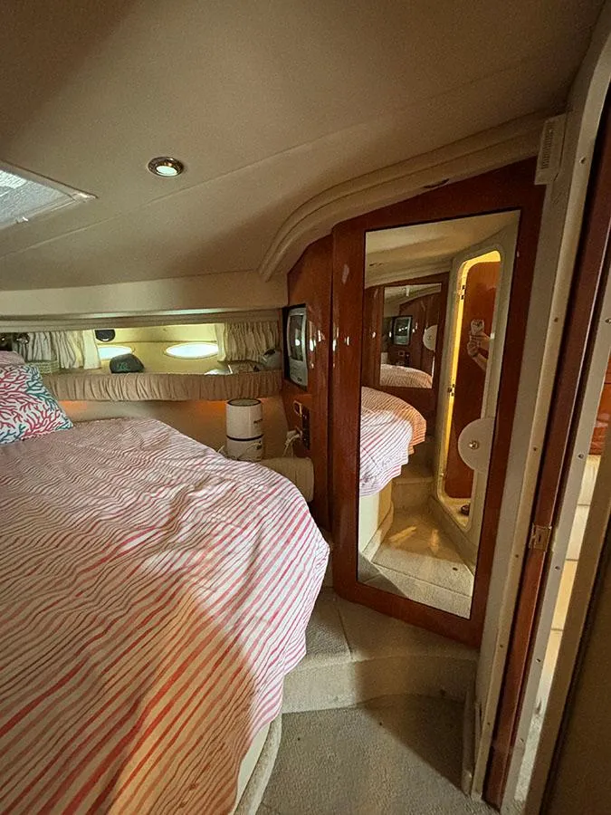 Slide: The Image of Interior cabin of 2001 Sea Ray 410 Sundancer yacht with bed and mirrored door. - 20