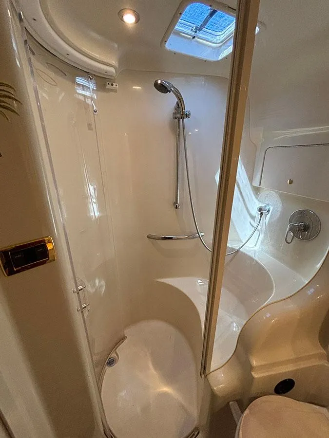 Slide: The Image of 2001 Sea Ray 410 Sundancer bathroom with shower and skylight. - 21