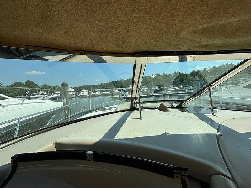Slide: The Image of View from the helm of a 2001 Sea Ray 410 Sundancer at a marina. - 32