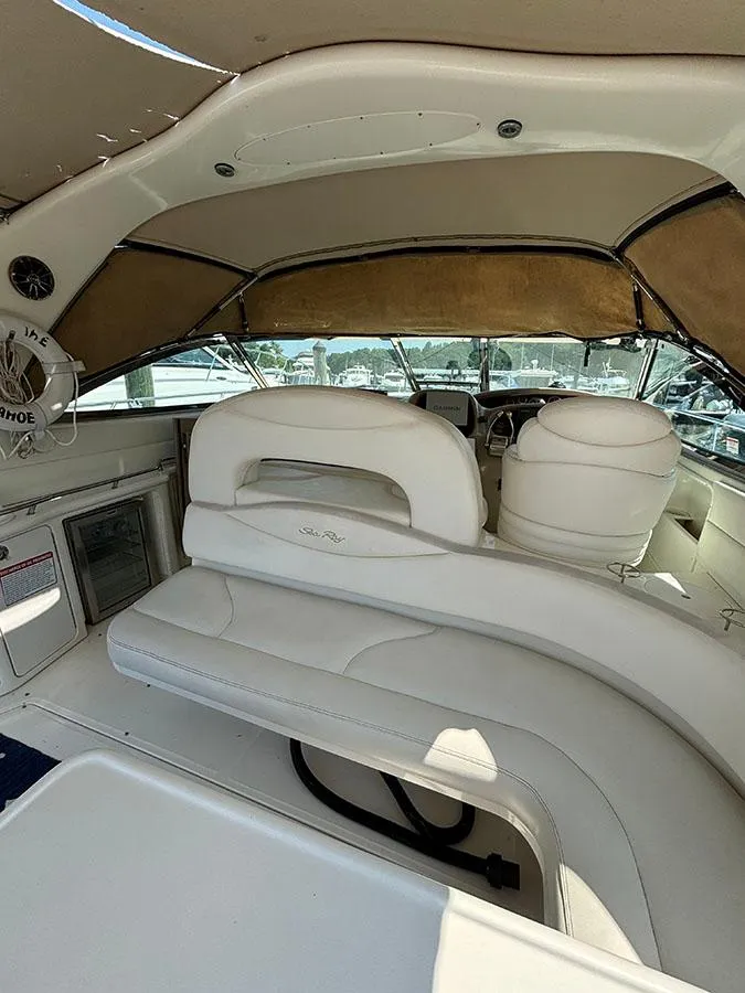 Slide: The Image of 2001 Sea Ray 410 Sundancer interior with white leather seating and helm station. - 8