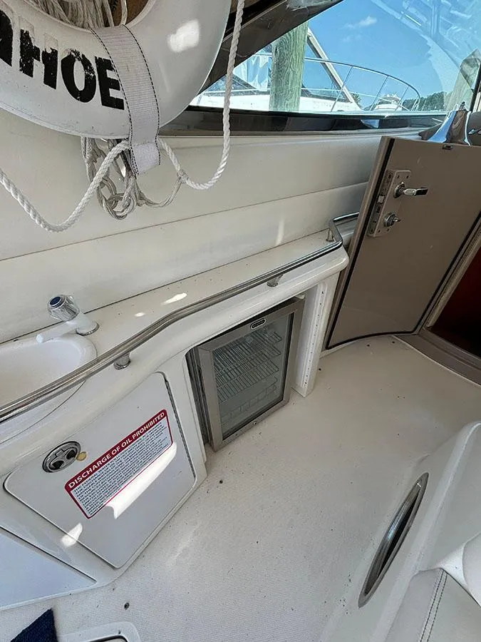 Slide: The Image of Interior of 2001 Sea Ray 410 Sundancer boat with life preserver and storage compartments. - 9