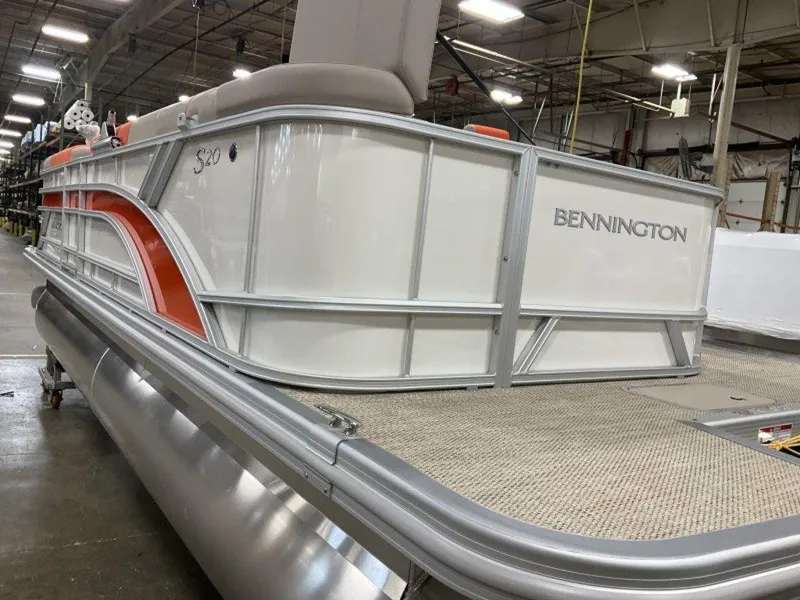 Slide: The Image of 2024 Bennington 20 SL pontoon boat in a warehouse. - 10