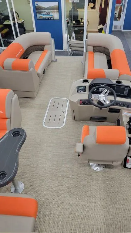 Slide: The Image of 2024 Bennington 20 SL pontoon boat interior with orange and beige seating. - 11