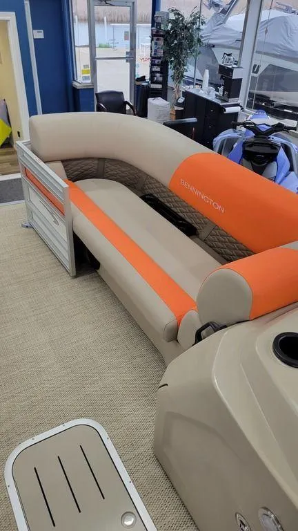 Slide: The Image of 2024 Bennington 20 SL pontoon boat with orange and beige seating. - 12