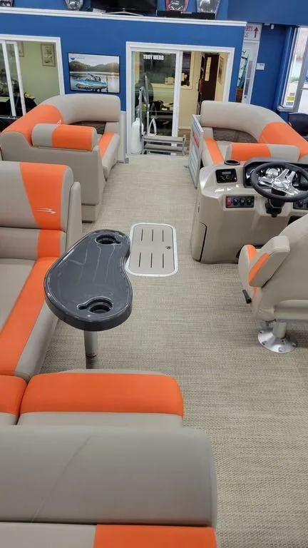 Slide: The Image of 2024 Bennington 20 SL pontoon boat interior with orange and beige seating. - 16