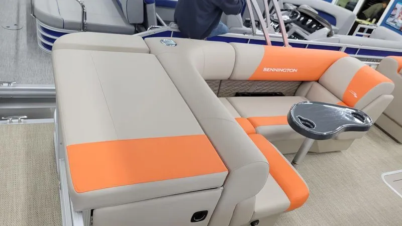 Slide: The Image of 2024 Bennington 20 SL pontoon boat with orange and beige seating. - 17